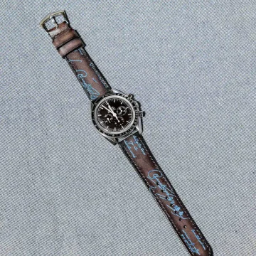Black Patina with Blue Scritto Strap on Omega Speedmaster by Gunny Straps